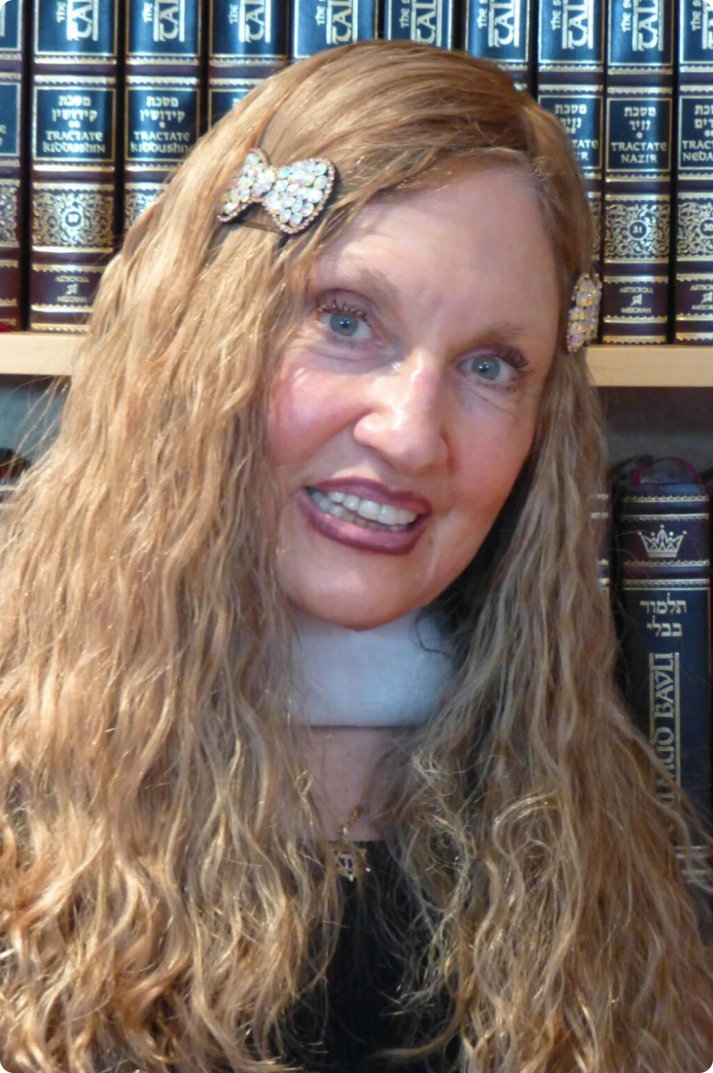 Smiling woman in front of books